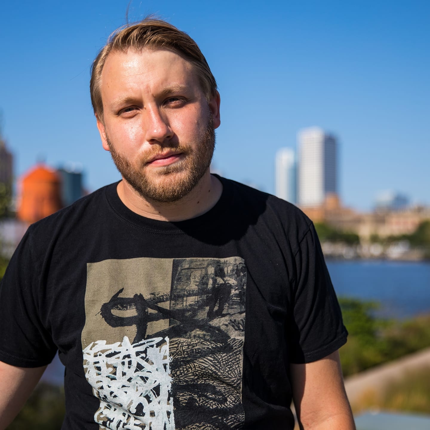 Portrait of writer, podcaster, and music media personality Allen Halas in front of the Milwaukee skyline